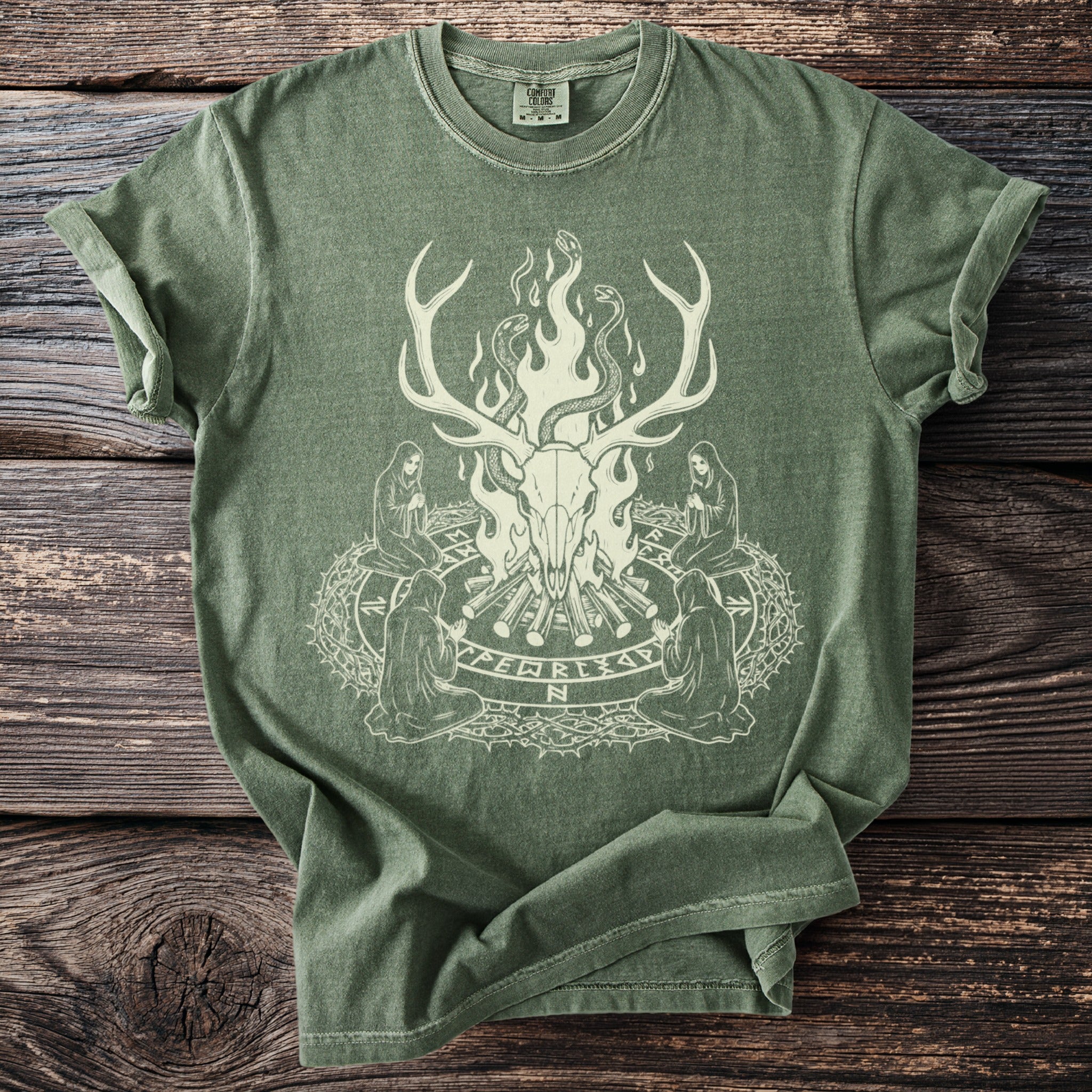 Green t-shirt with a light print of a deer skull, snakes, and robed figures around a circle.
