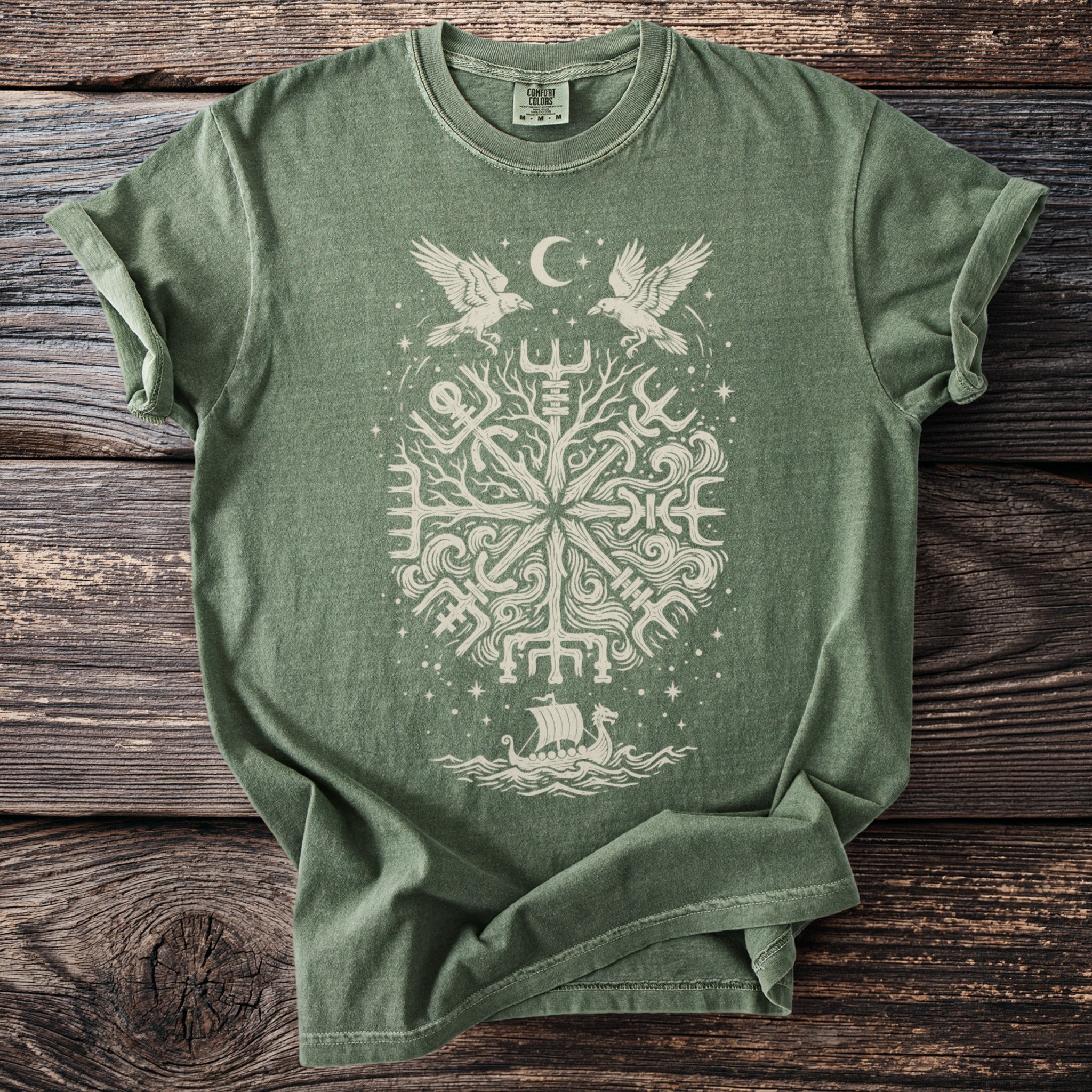 Green t-shirt with white Norse pagan symbol featuring ravens, moon, and a longship.