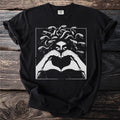 Black t-shirt featuring Medusa graphic with snakes and hands forming a heart.