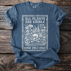 Blue t-shirt with white text and illustration of skull, bones, and plants.