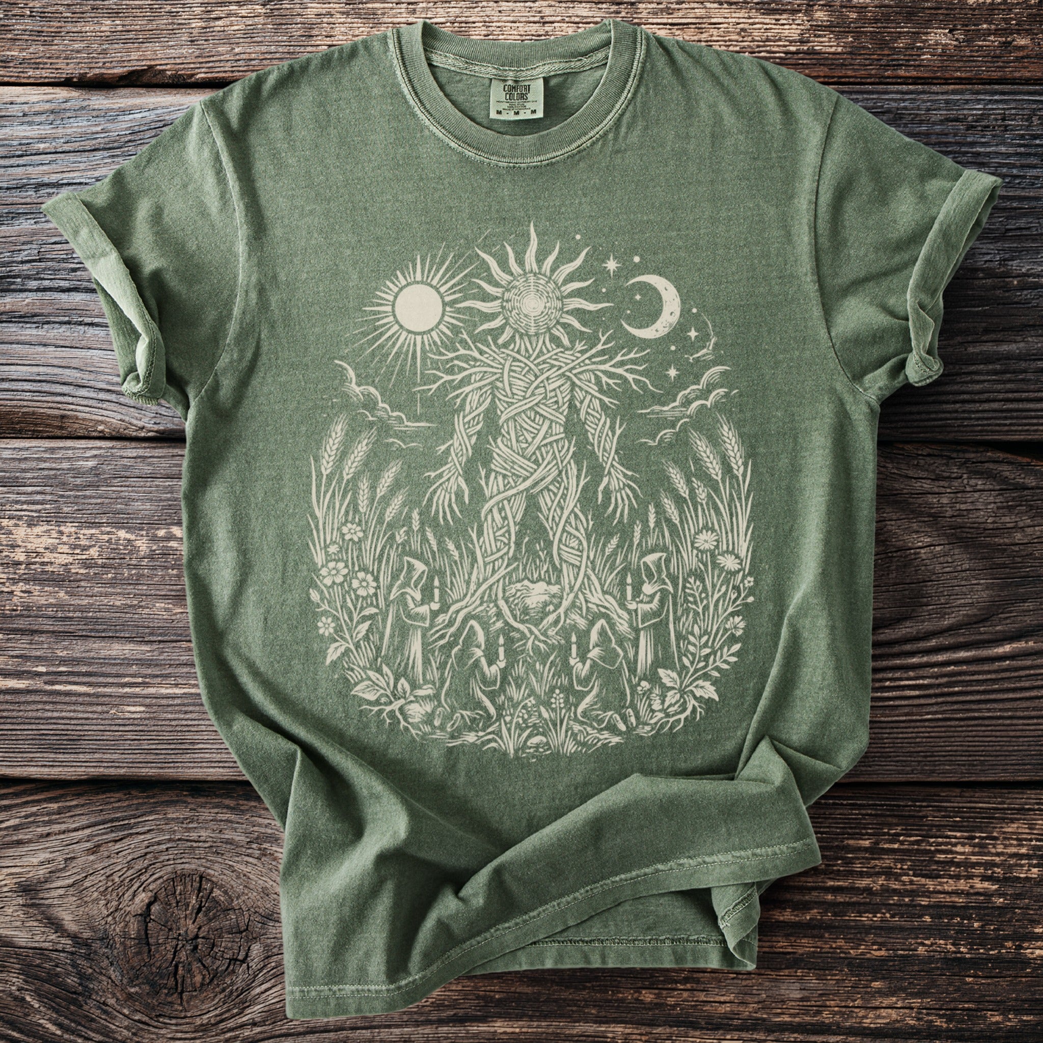 Green Comfort Colors t-shirt with light tan nature-themed graphic design.