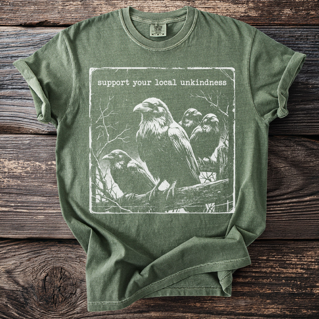 Green t-shirt with ravens graphic and text "support your local unkindness".