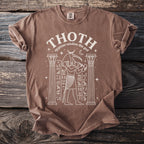 Brown t-shirt with white graphic of Thoth the Egyptian ibis god and hieroglyphs.
