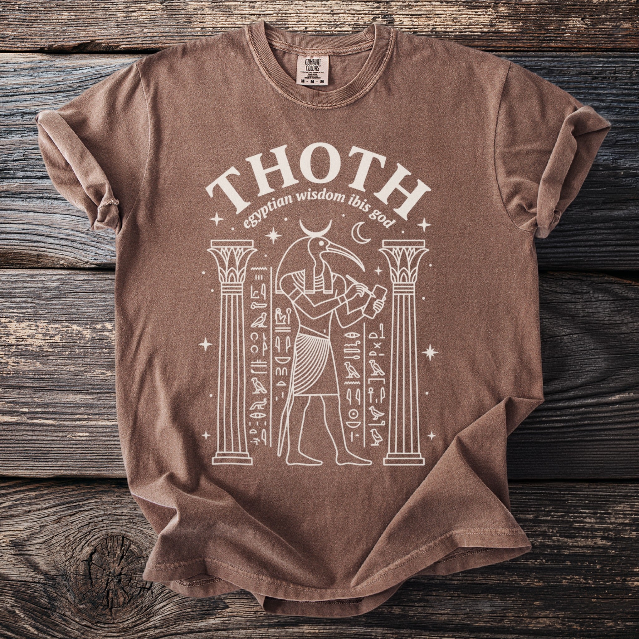 Brown t-shirt with white graphic of Thoth the Egyptian ibis god and hieroglyphs.