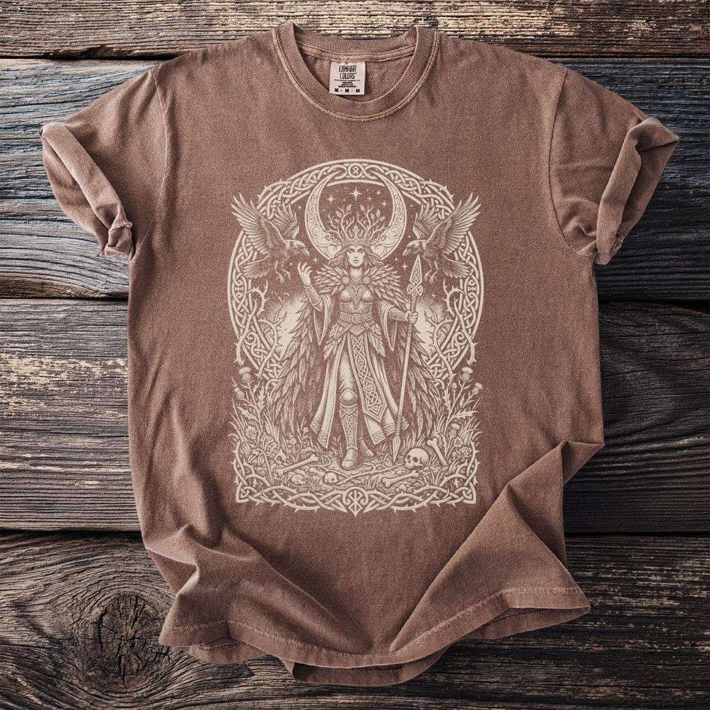 Brown t-shirt with a detailed cream line drawing of a mythical goddess surrounded by ravens and Celtic knotwork.