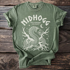 Green t-shirt with white graphic of Nidhogg, the Norse mythology root serpent.