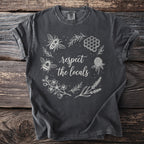 Dark gray t-shirt with white floral design, two bees, and text "respect the locals".