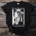 Black t-shirt with a graphic of a werewolf doing laundry and text "it's not the moon i'm just like this".