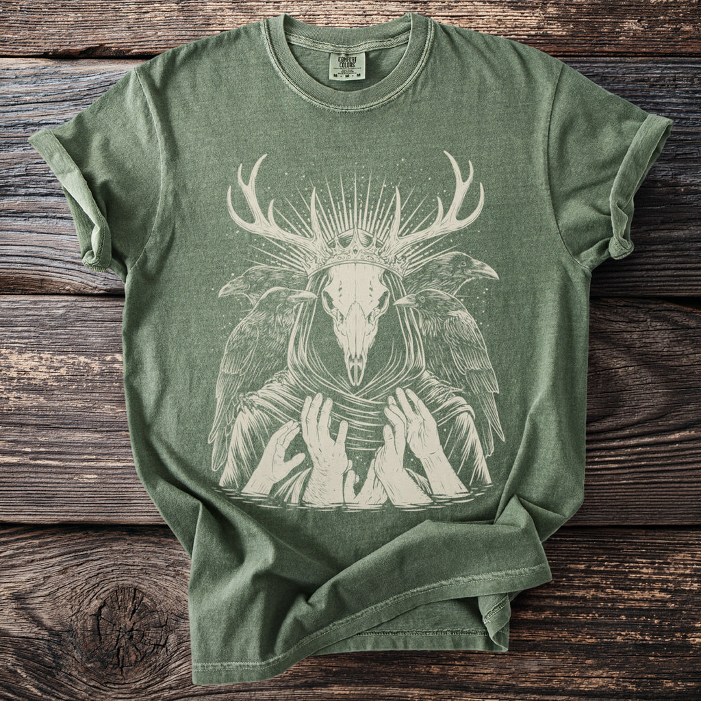 Green t-shirt with a light-colored graphic of a deer skull wearing a crown and surrounded by ravens.