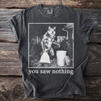 Dark grey t-shirt with graphic of werewolf taking out trash, reads "you saw nothing".