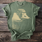 Green t-shirt with a faded beige duck graphic, size M tag displayed.