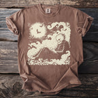 Brown t-shirt with a cream graphic of a skeleton in smoke under a moon with bats.