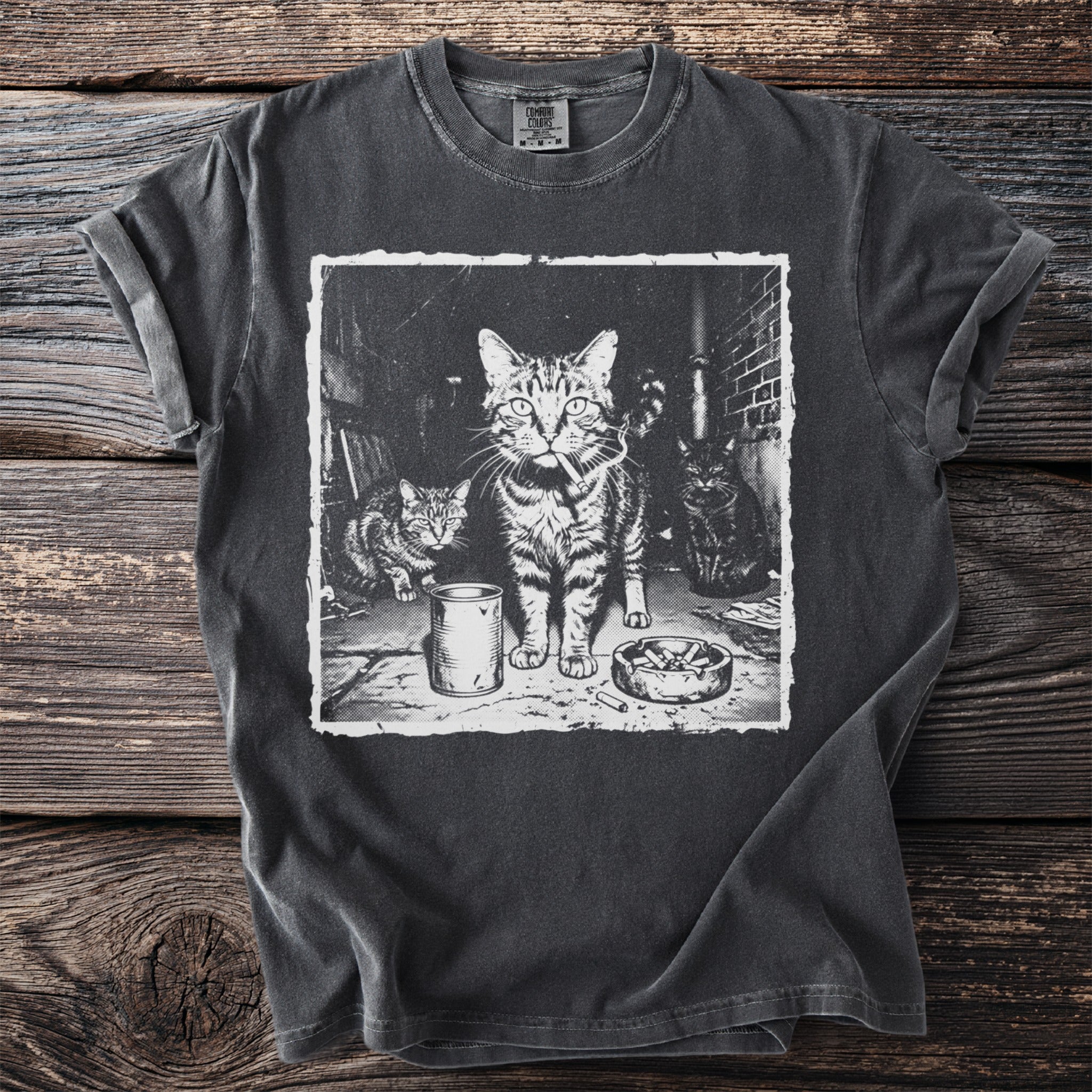 T-shirt with graphic print of three cats, one smoking amidst an ashtray and cans.