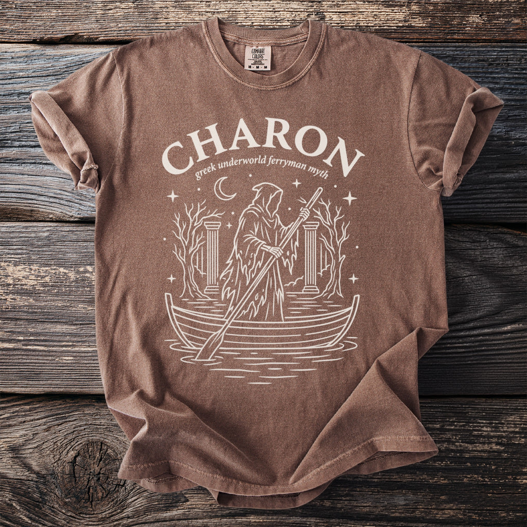Brown t-shirt with white graphic of Charon, Greek underworld ferryman, in a boat.
