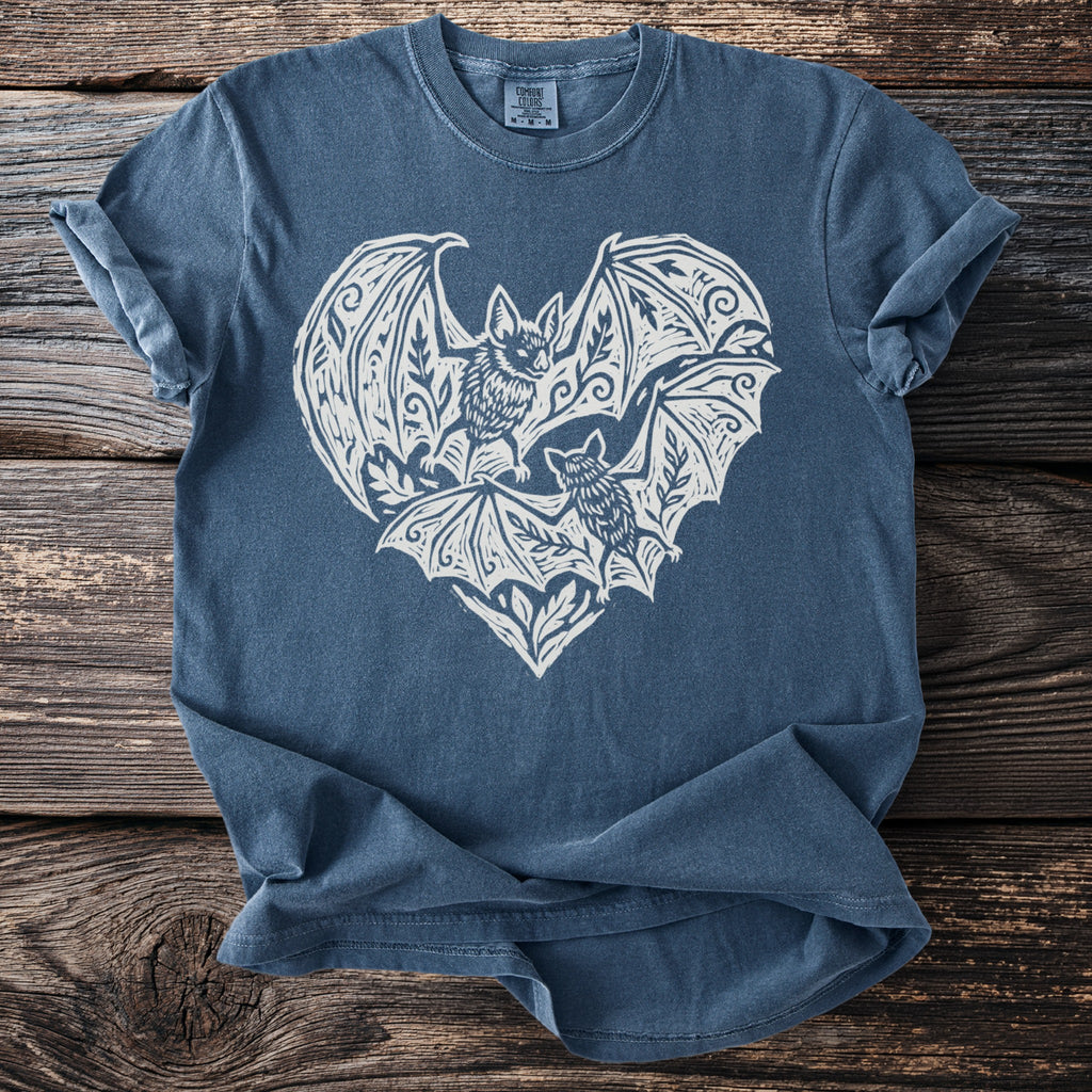 Blue t-shirt with white graphic of two bats forming a heart shape.