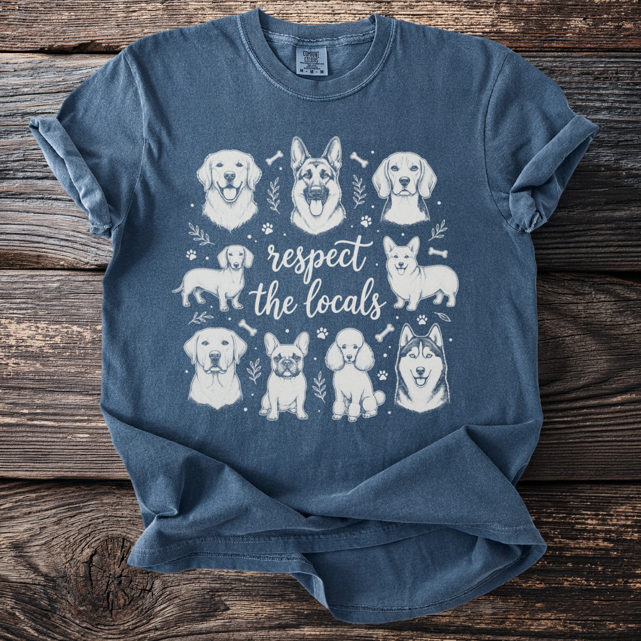 T-shirt with sketch art of various dog breeds and text "respect the locals."