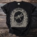 Black t-shirt with a cream-colored, framed botanical illustration of a dragonfly and woodland plants.