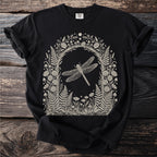 Black t-shirt with a cream-colored, framed botanical illustration of a dragonfly and woodland plants.