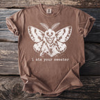 Brown t-shirt with white moth graphic and text "i ate your sweater".