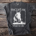 Dark grey t-shirt with white text and a horse smoking a cigarette.
