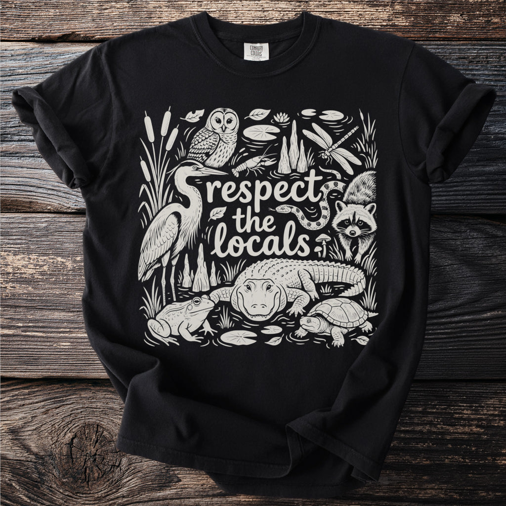 Black t-shirt with swamp animals and "respect the locals" text.