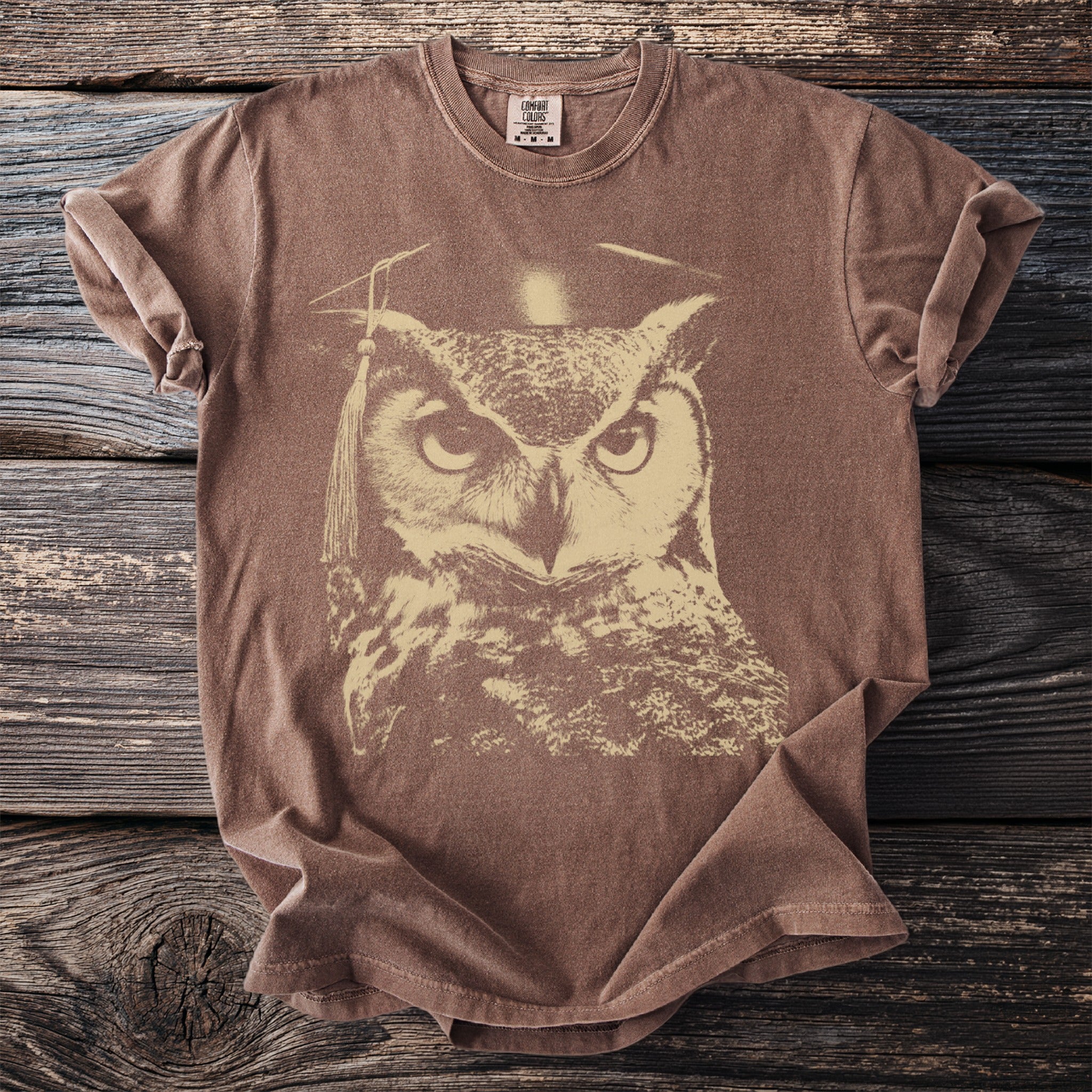 Brown t-shirt with a light tan graphic of an owl wearing a graduation cap.