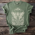 Green t-shirt with mystical moth woman, moon phases, and floral design.