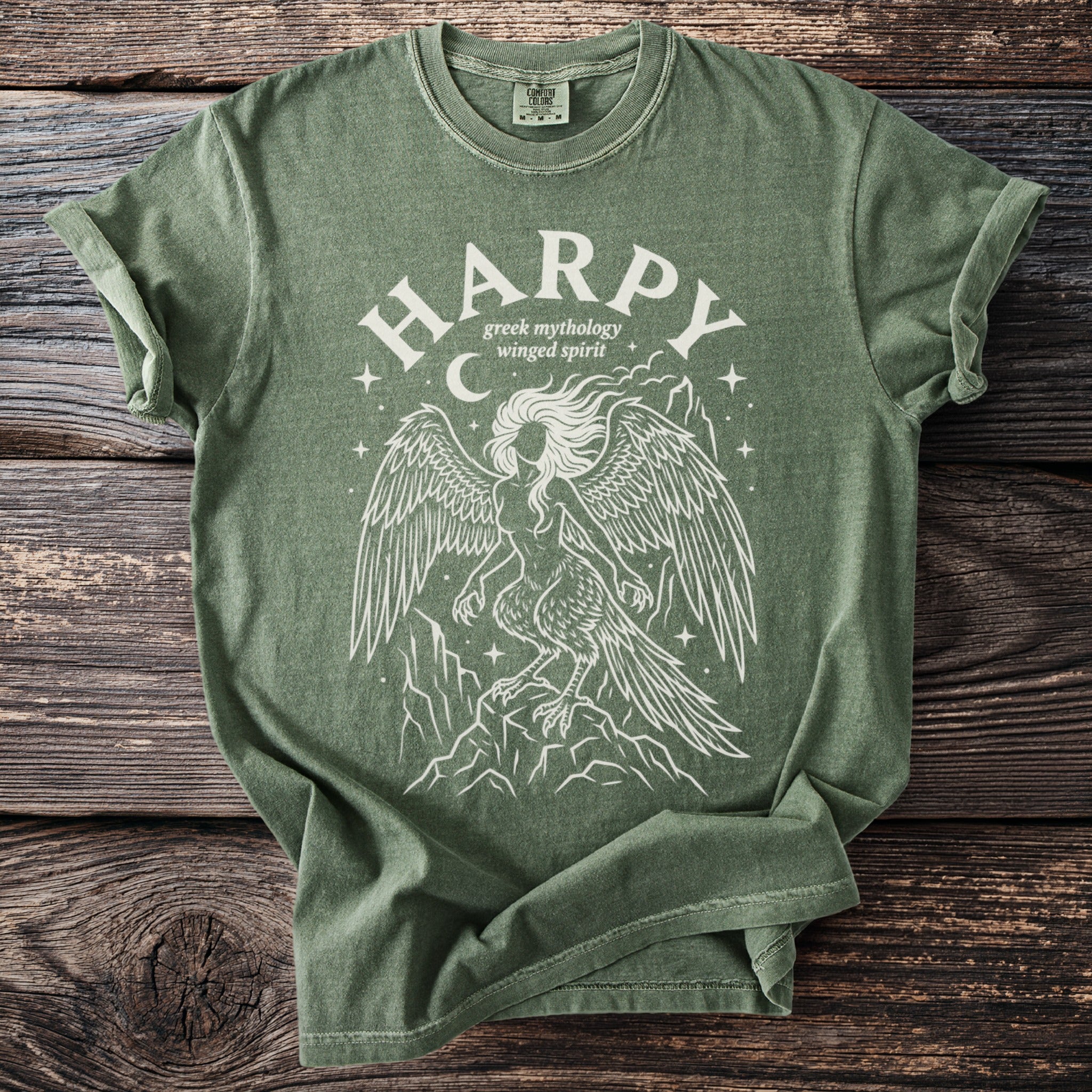 Green t-shirt with white "HARPY greek mythology winged spirit" design and a harpy illustration.