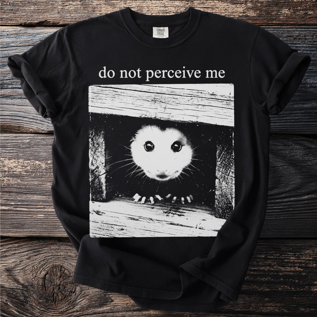 Black t-shirt front graphic with possum peeking out and text "do not perceive me".