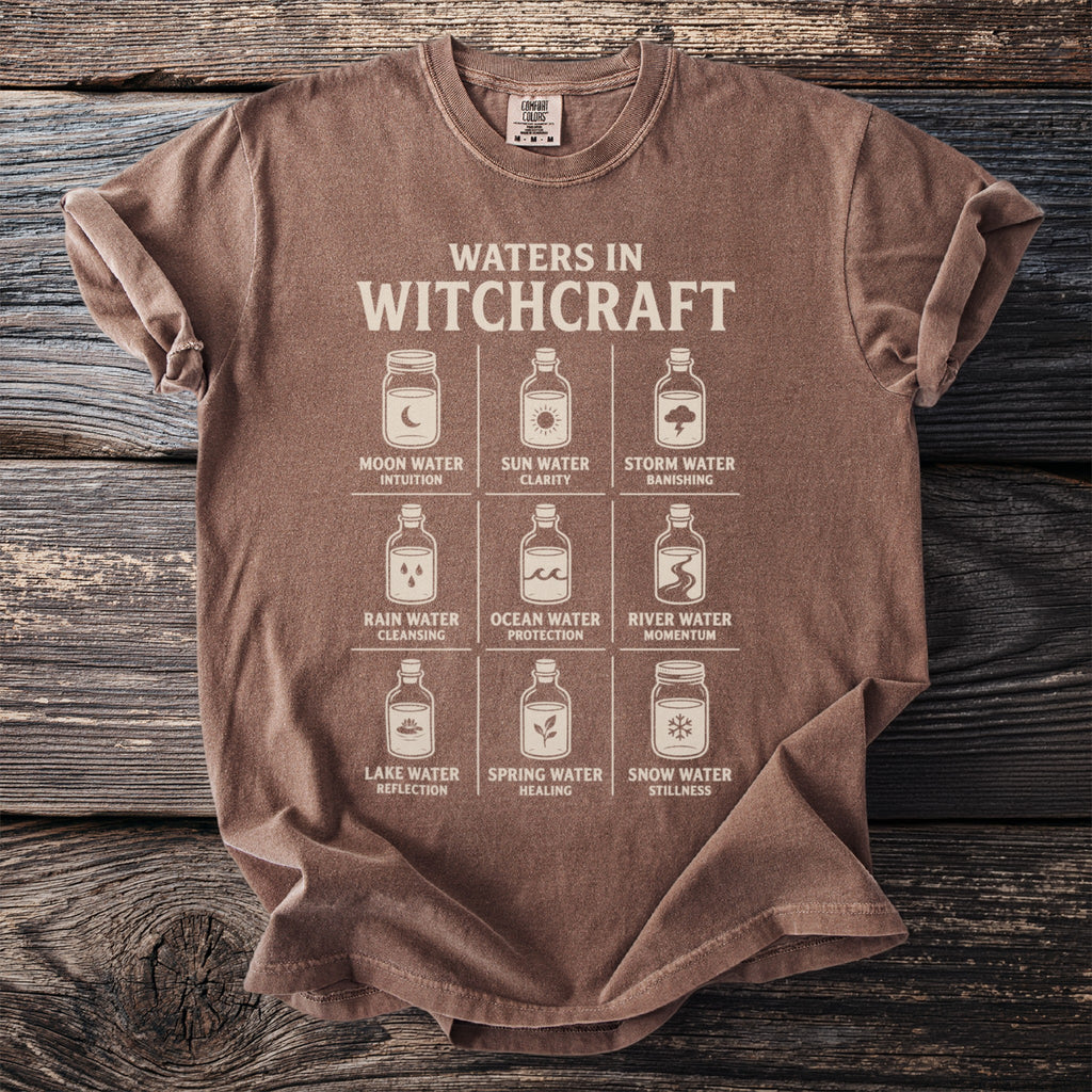 T-shirt with "Waters in Witchcraft" graphic showing nine types of water in jars.