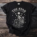 Black t-shirt with "The Star tarot card arcana hope celestial" text and tarot imagery.