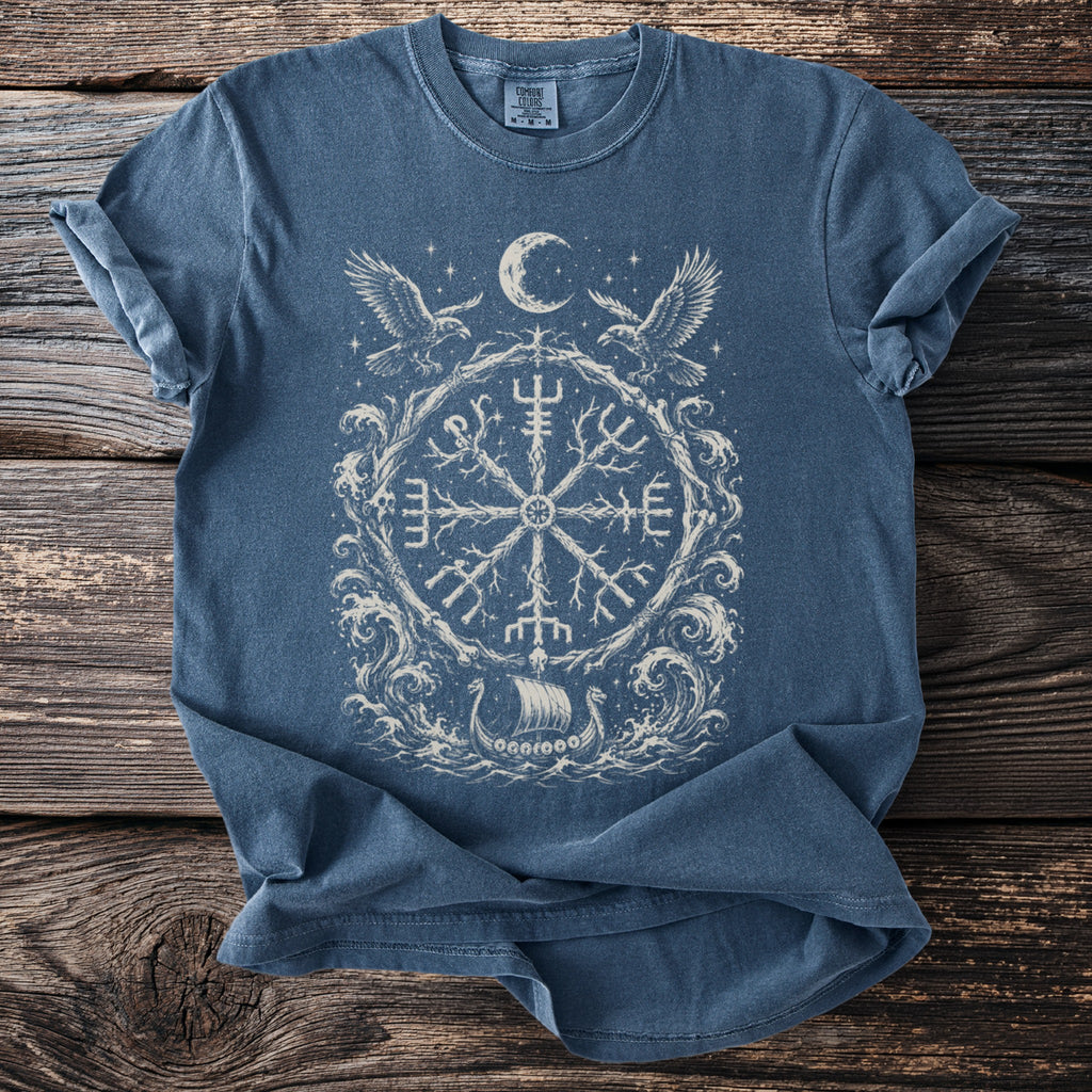 Blue t-shirt with white Viking-inspired circular graphic featuring a ship, ravens, and moon.