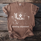 Brown t-shirt with a graphic of three cats sitting at a table, text reads "meeting adjourned".