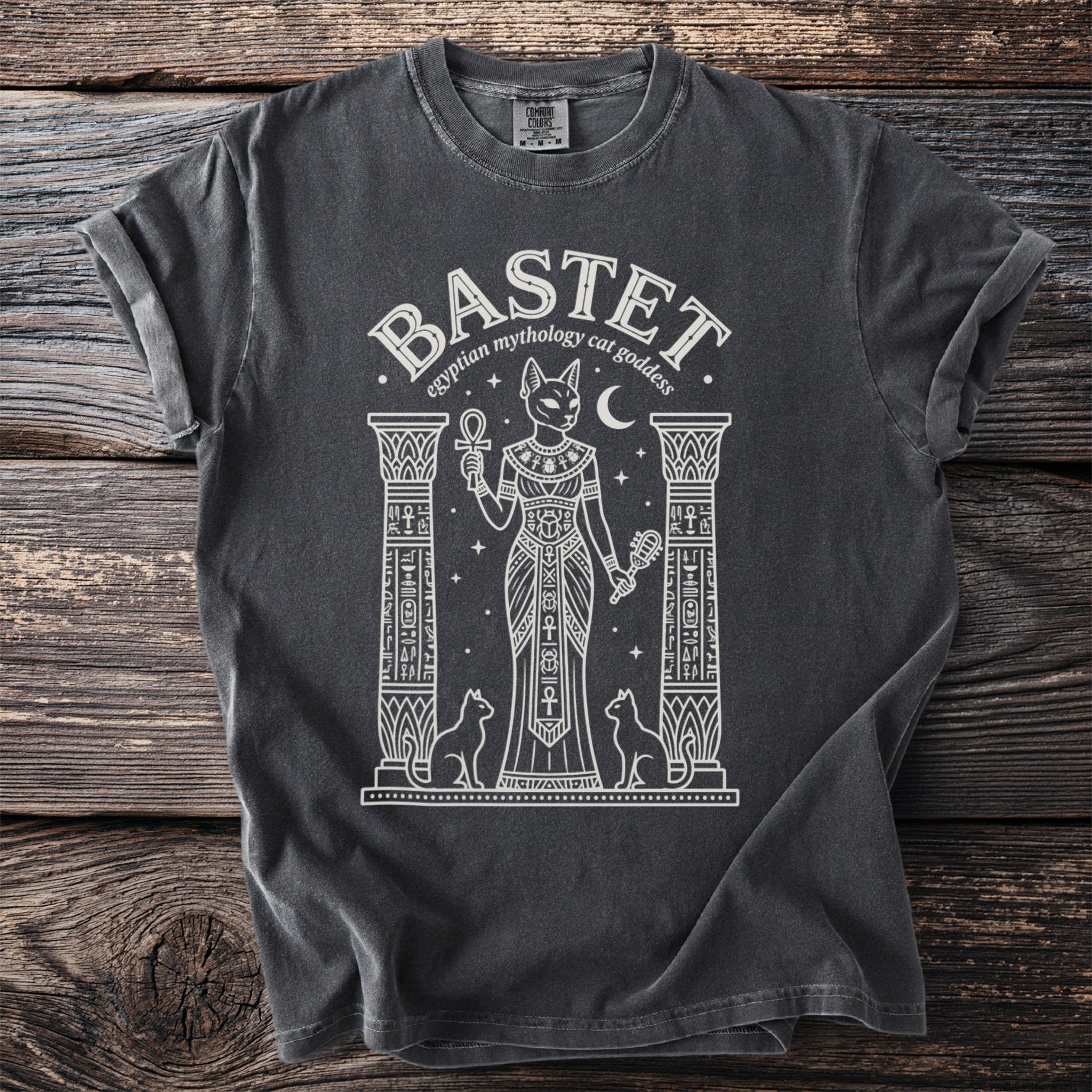 Front of t-shirt with "BASTET egyptian mythology cat goddess" and feline goddess graphic.