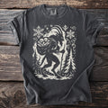 Dark grey t-shirt with a cream silhouette of Krampus carrying a sack of bones.