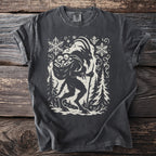 Dark grey t-shirt with a cream silhouette of Krampus carrying a sack of bones.