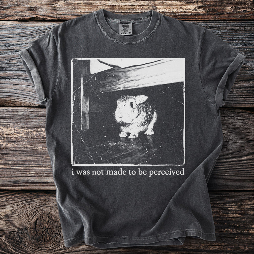 Dark t-shirt with a black and white image of a rabbit and text.