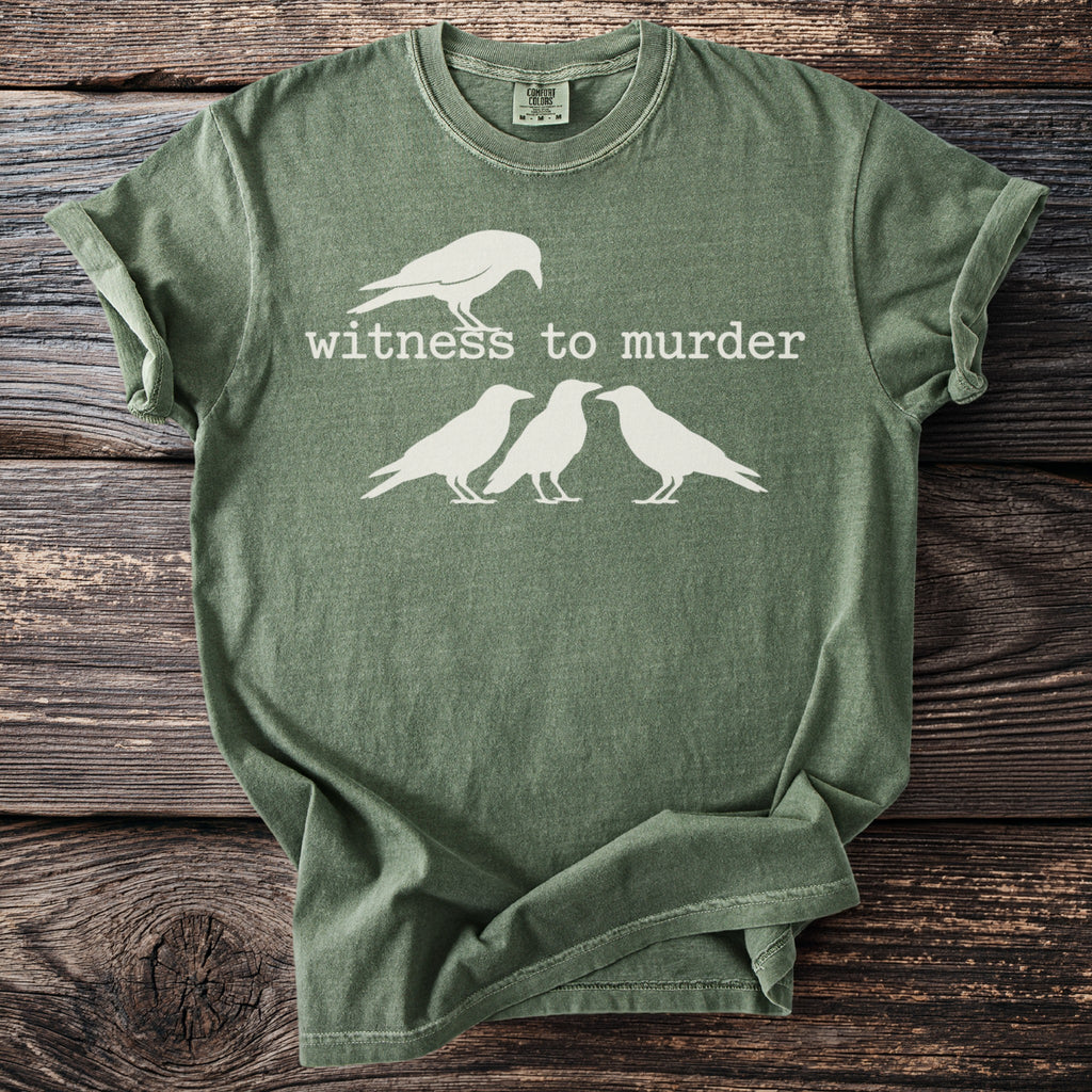 Green t-shirt with white text "Witness to Murder" and four white crows.