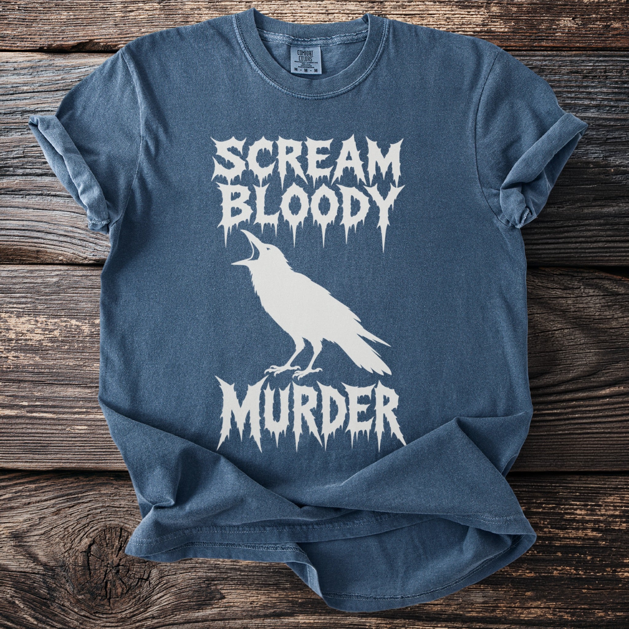 Blue t-shirt with white text "SCREAM BLOODY MURDER" and a crow graphic.