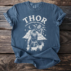 Blue t-shirt with Thor graphic, mjolnir hammer, goats, and thunder god text.