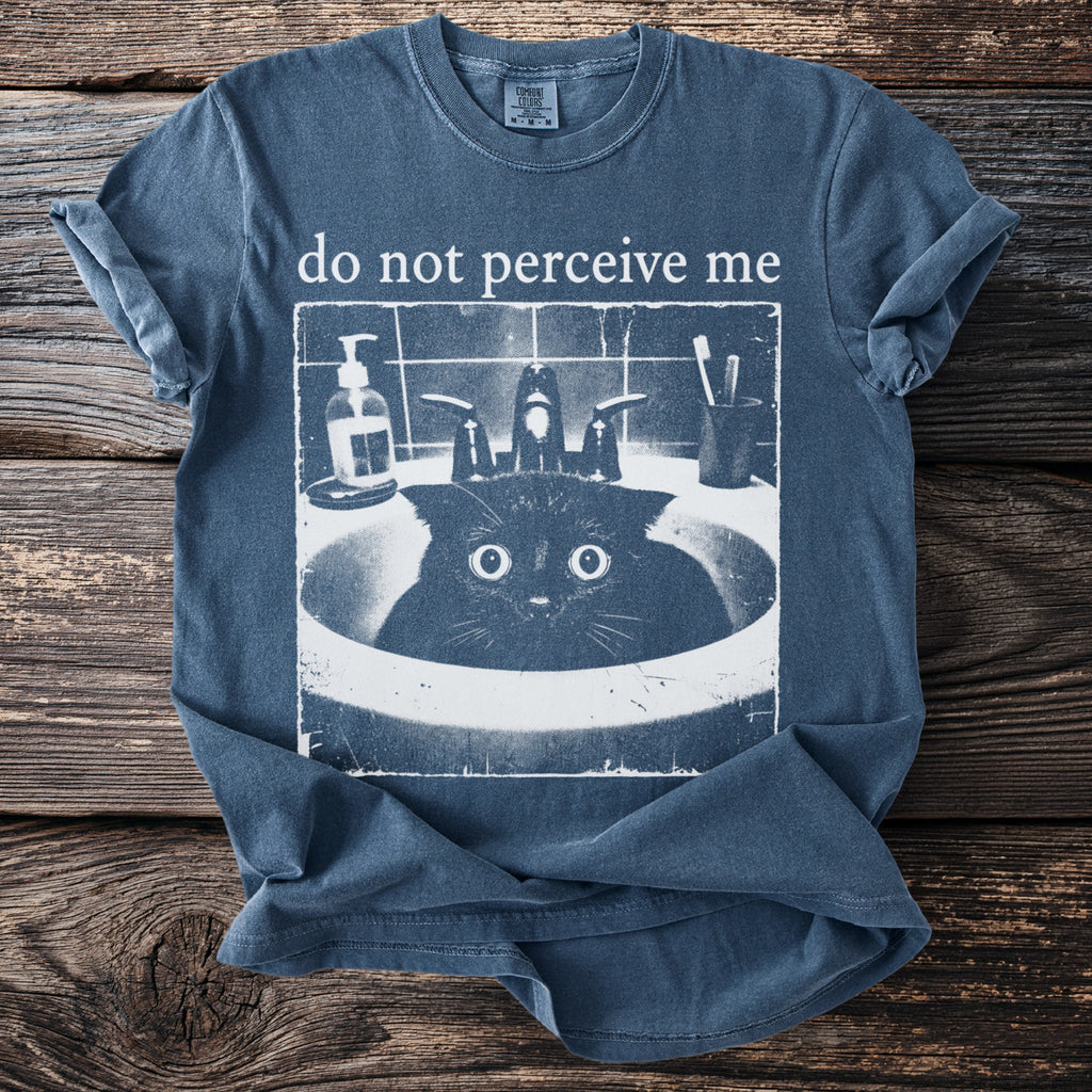 T-shirt with a black cat peeking out of a sink with text "do not perceive me".