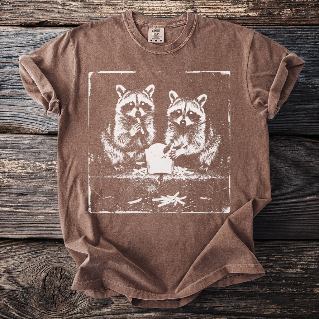 Brown t-shirt featuring a distressed graphic of two raccoons eating french fries.