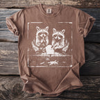 Brown t-shirt featuring a distressed graphic of two raccoons eating french fries.