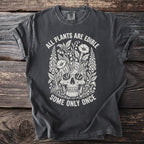 Dark gray t-shirt with skull and floral graphic, reading "All Plants Are Edible, Some Only Once."
