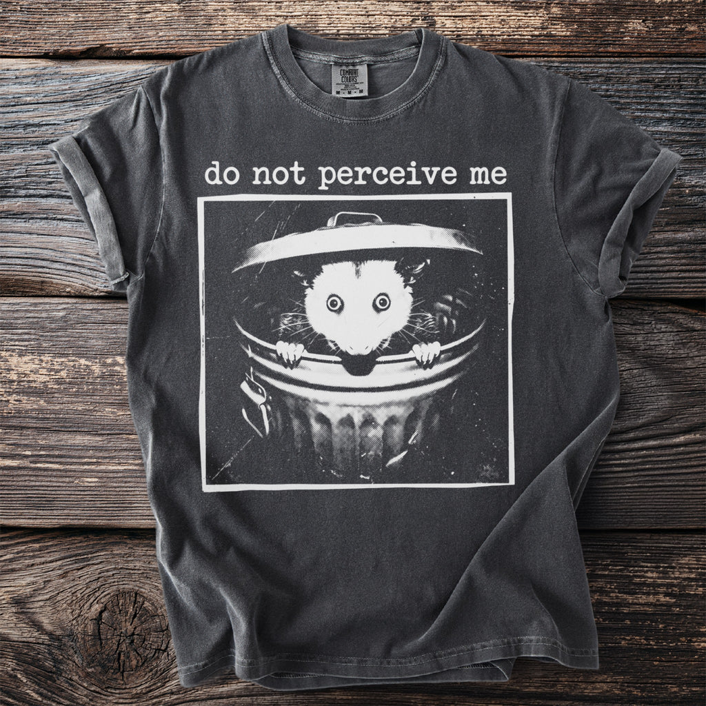 Dark gray t-shirt with a graphic of an opossum in a trash can and the text "do not perceive me".