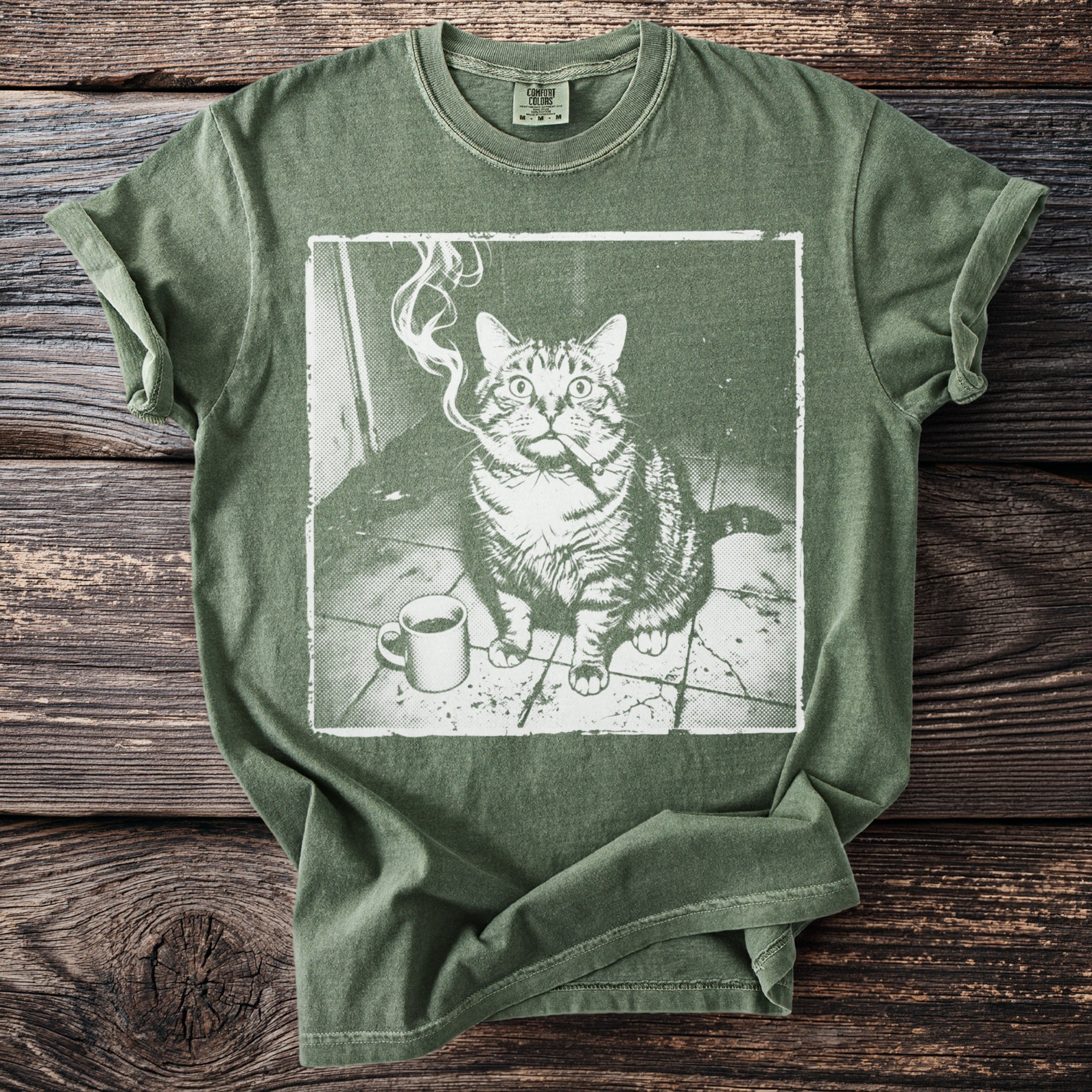 Green t-shirt with a graphic of a cat smoking a cigar next to a coffee cup.