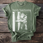 Green t-shirt with "barely functioning" text above a wolf opening a door.