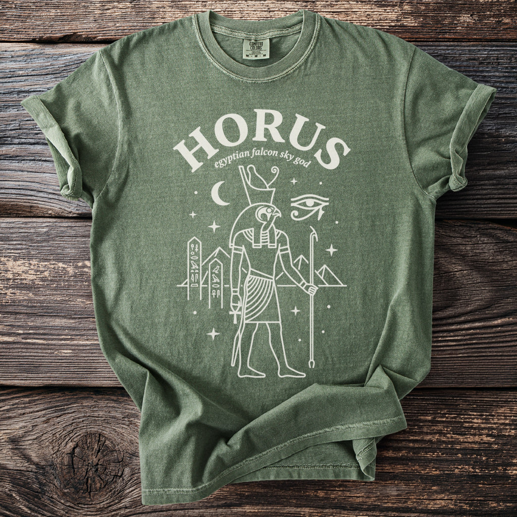 Green t-shirt with white line art of Egyptian falcon god Horus.