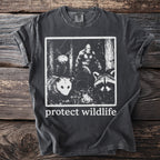 Charcoal t-shirt with graphic of Bigfoot, possum, raccoon, and moth with "protect wildlife" text.
