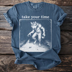 Werewolf in ripped jeans on a path with a snail, text "take your time".